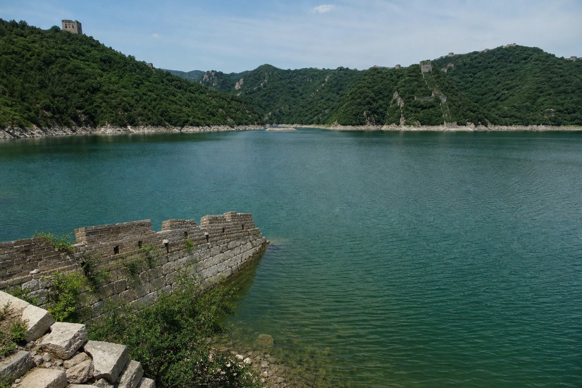 The Huanghuacheng lakeside Great Wall, where stone ramparts run down toward a broad reservoir
