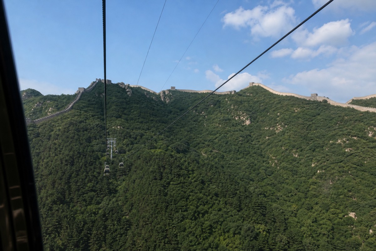 Cable car climbing toward the wall at Mutianyu with the ridge ahead for hiking the Great Wall of China