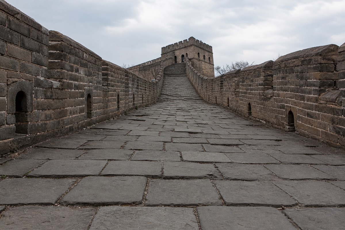 A runner running the Great Wall Marathon along a stone path near Beijing